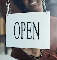 Bright and informative sign showing the business hours for a storage unit facility, highlighting customer convenience and accessibility.